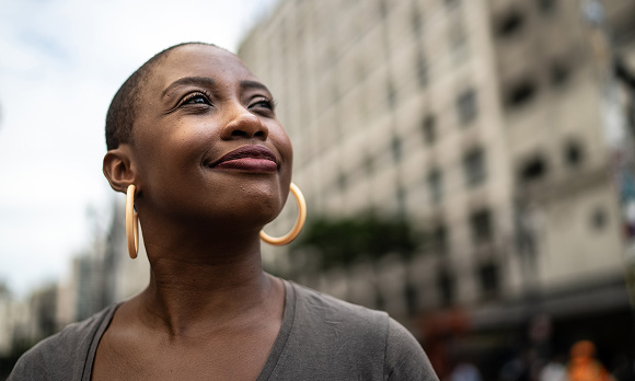 woman in a city smiling
