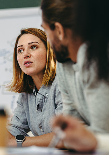 group of office workers talking with main focus on one female