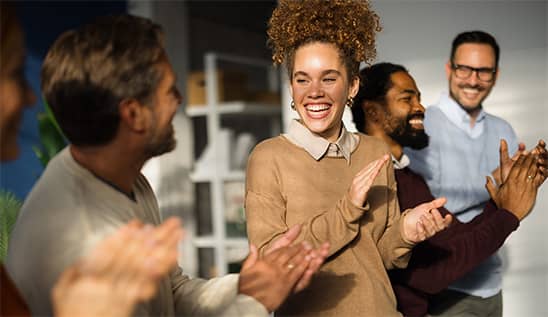 group of people clapping and smiling